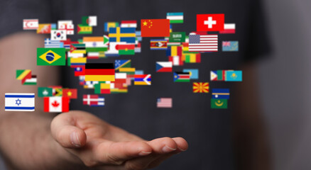 Image of a hand holding various national flags, symbolizing global unity and international...