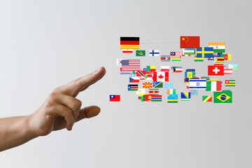 Image of a hand pointing at a Taiwan flag among a network of various world flags. Global...