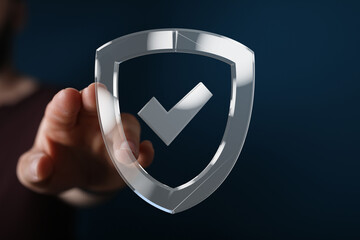 Hand interacts with a digital shield, symbolizing data security and online protection.
