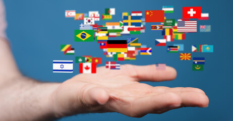Image of a hand holding many flags representing global connections and international relations.