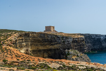 Comino, Malta - May 4th 2022: Saint Mary's Tower, a Wignacourt Tower also known as the Comino Tower on the clifftop.. 