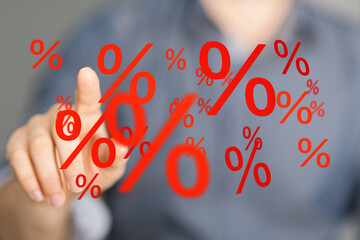 Red percentage symbols floating, hand interacting, illustrating discounts, sales, finance, interest...