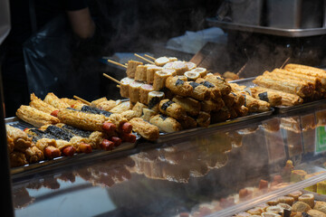 Korean street food skewers with warm, inviting mood, freshly cooked at Seoul, South Korea, Myeongdong Market stall