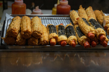 Korean street food with a tempting mood, hot dog tempura and seaweed rolls on display at Myeongdong Market, Seoul, South Korea