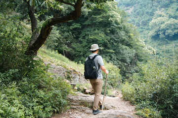 asian man hiking in mountain