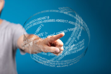 Person interacts with a digital sphere showing code and data, technology concept.