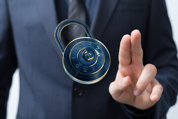 Image of a businessman's hand interacting with a digital padlock, symbolizing online security and...