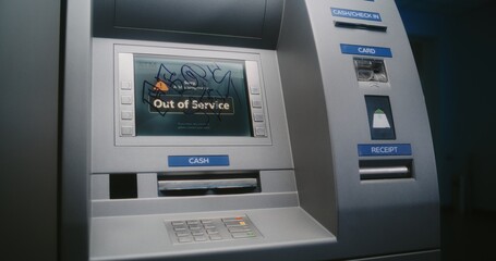 Unrecognizable Vandal in Hoodie Marking ATM Screen with Graffiti Using Marker Pen. Person Damaging Property, Vandalizing Out of Service Cash Machine with Illegal Graffiti. Vandalism in Public Place.