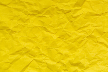 Close-up of yellow crumpled paper backdrop,Wrinkled yellow paper surface,blank crumpled yellow paper for background 