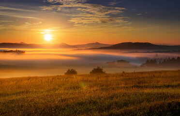 Generated Breathtaking sunrise over misty hills and valleys, captured during the golden hour. The soft morning fog, warm light, and serene natural landscape create a peaceful and atmospheric countrysi