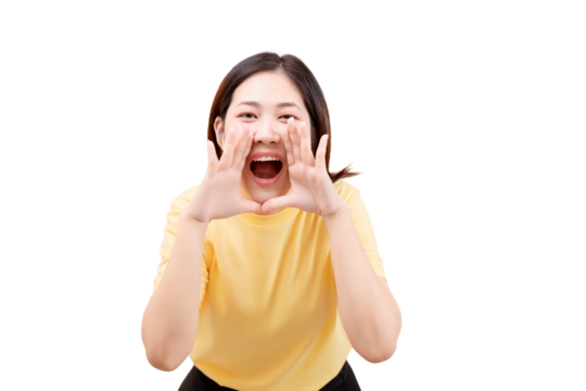 Asian young beautiful woman in a yellow shirt shouts with her hands around her mouth.