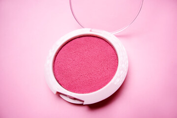 Pink blush palette resting on pink background with open lid