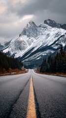 Road Leading to Majestic Mountains Under Clear Blue Sky in Early Morning Light.