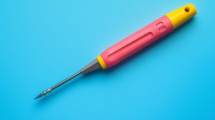 The screwdriver, brightly colored, rests on a smooth blue surface, demonstrating its ergonomic design and versatility in handling different tasks
