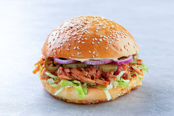 Juicy Pulled Pork Sandwich Layered with Fresh Lettuce and Pickles