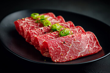 raw korean beef sliced meet on black marble plate, agains white background
