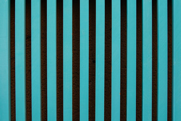 turquoise wooden slats vertically forming a pattern