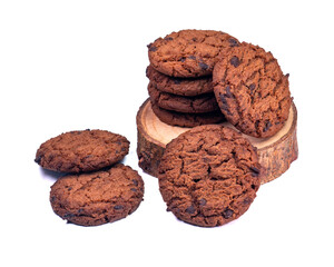 Crispy chocolate chip cookies arranged on a round wooden base with a white background, perfect for food content or advertising.