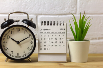 Hello, December 2025. A desktop calendar for planning on the table.