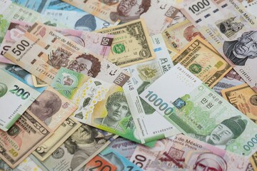 Big amount of money bills of different currencies and countries. Assortment background of international cash in big pile close up
