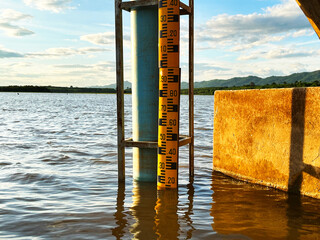 Water level at the dam, A water gauge stick in the middle of a river, showcasing accurate water...