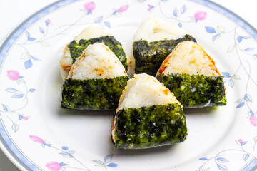 Classic Japanese Onigiri with seaweed wrap. Rice ball, healthy snack, traditional Asian food.