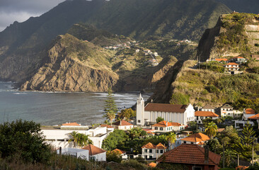 Picturesqu view of Porto da Cruz village with big impressive cliffs in the background. Madeira...