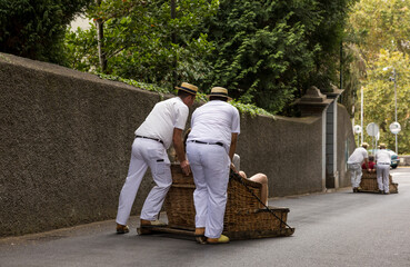 Group of (Carreiros) runners with traditional wicker basket car. The Monte Sledges.  Madeira...