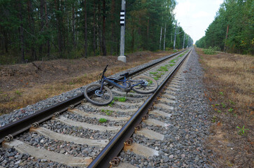 Bicycle crash on railroad. Railroad accident with cyclist. Broken bicycle between railroad rails....