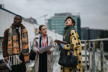 Multicultural team of people analyzing an urban development project together, showcasing collaboration and focus.