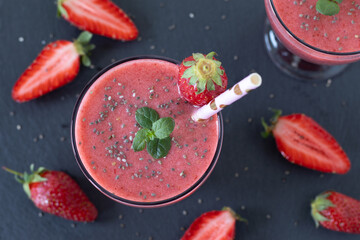 Strawberry chia seed smoothie on dark background. Top view. Healthy vegan summer drink.