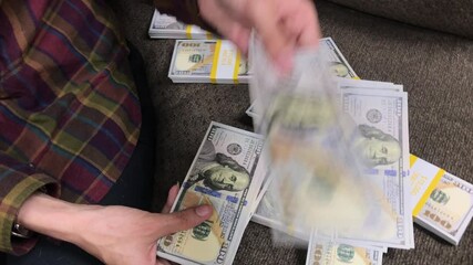 Young Woman Counts Stacks of Cash $100 Bills