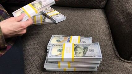 Young Woman Counts Stacks of Cash $100 Bills