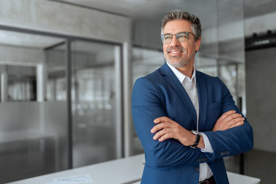 Portrait motivated executive confident senior business man specialist looking dreaming at copy space. Insipired indian or latin hispanic mature middle age boss, leader, ceo male businessman in office