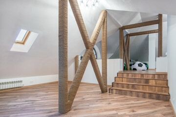 Beautiful design of the attic of a country house. White walls, parquet, original finish.