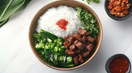 Nasi Padang with beef rendang, cassava leaves, and sambal, styled neatly on white surface.