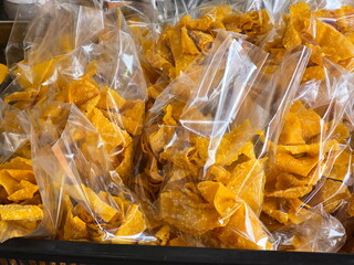 Fried Wontons, golden yellow, crispy, delicious, packed in clear bag for sale. Deep Fried Wonton Wrapped With Seasoned Minced Pork. Serve with sweet chili sauces. Snacks packed in bags for consumption