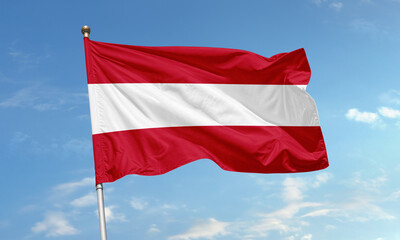 Austria national flag waving proudly in the wind on a sunny day with clear blue sky background