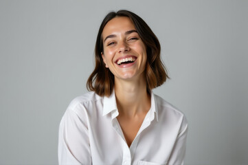 A happy woman wearing a white shirt, perfect for various social media posts or blog articles