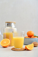 Orange fresh squeezed juice in glass and glasses jug