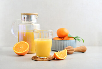 Orange fresh squeezed juice in glass and glasses jug
