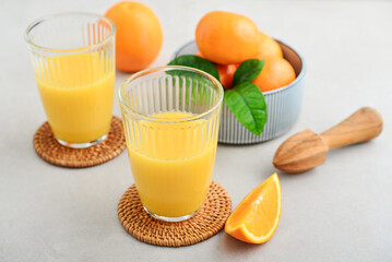 Orange fresh squeezed juice in glass and glasses jug