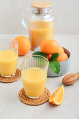 Orange fresh squeezed juice in glass and glasses jug