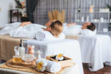 Aromatherapy massage on daylight ambiance or spa salon composition setup with focus decor and spa accessories on blur woman enjoying blissful aroma spa massage in resort or hotel background. Quiescent