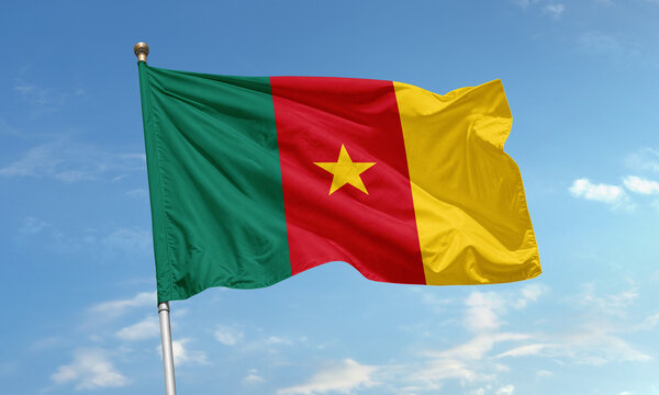 Cameroon national flag waving in the sky with bold green, red, and yellow vertical stripes and a central yellow star - Powered by Adobe