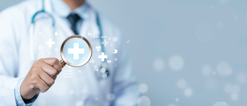 Medical checkup concept. The doctor is holding a magnifying glass with healthcare icon to Annual health check on hospital or clinic. Medical Examination service. Assessment and disease diagnosis.
