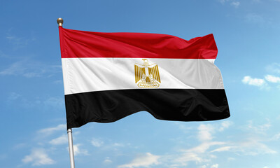 Egypt national flag with golden eagle emblem waving in the sky