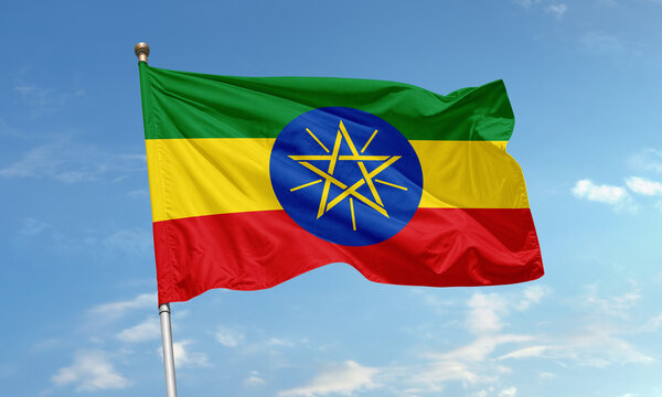 Ethiopian national flag with star emblem waving in the sky - Powered by Adobe