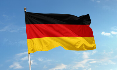 German national flag with black red gold stripes waving in sky