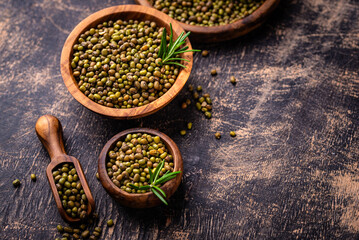 Raw uncooked mung beans on black background
